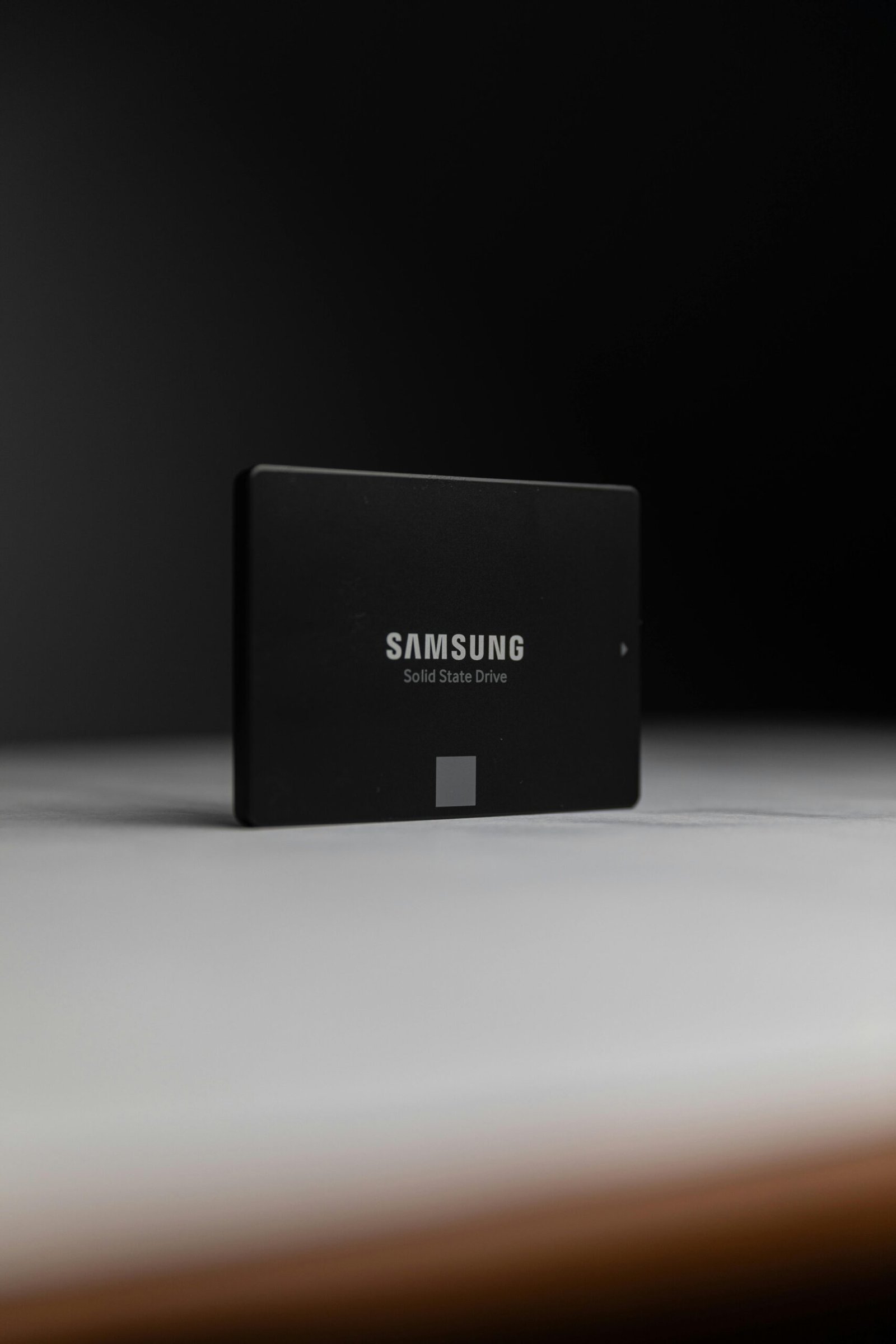 Close-up of a Samsung solid-state drive on a dark surface, modern technology.
